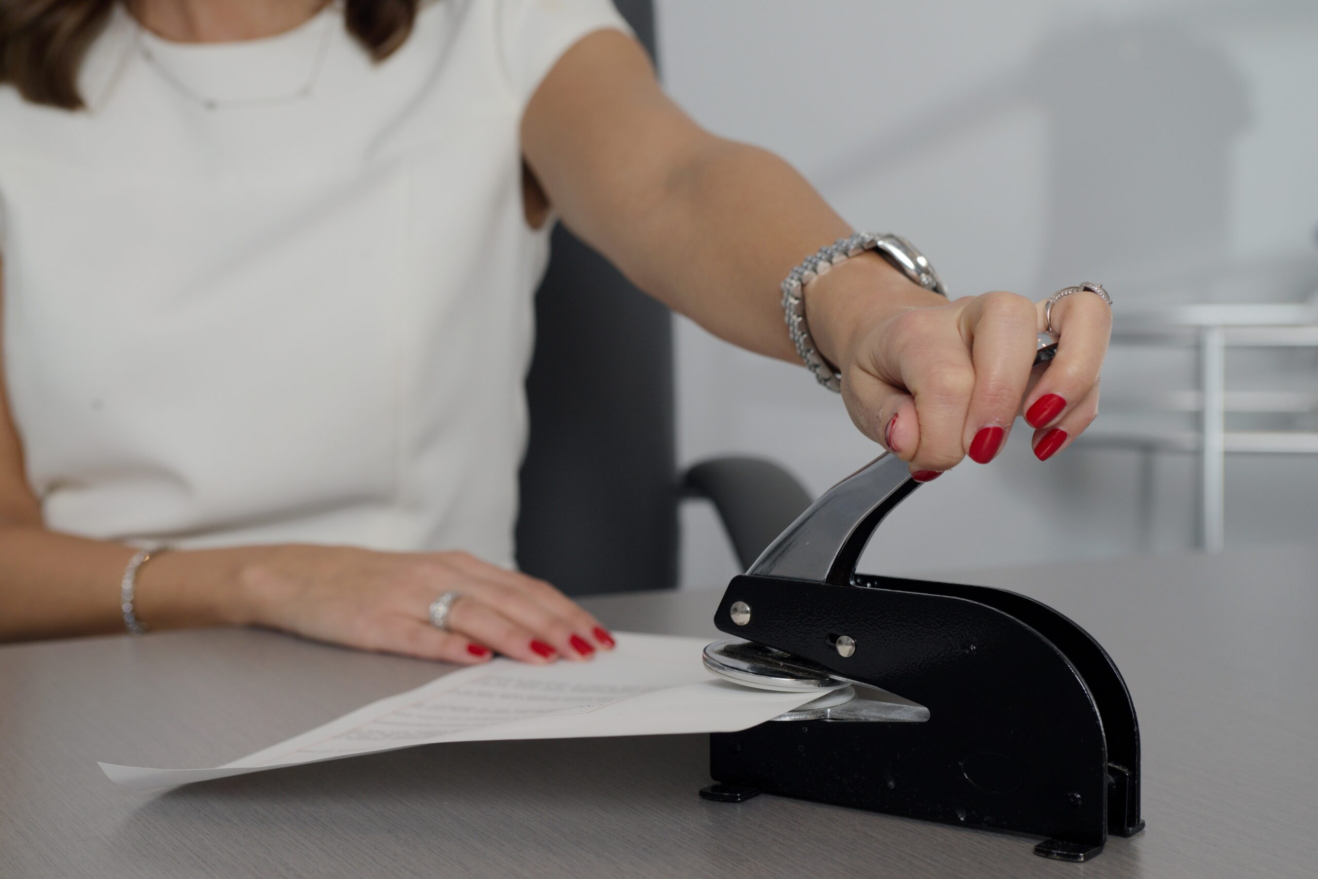 woman applying notary seal to a document